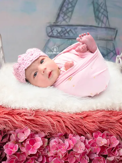 A little bit of Parisian charm for this baby girl. With the Eiffel Tower in the background and a bed of pink flowers, this is a truly romantic and sweet setup.