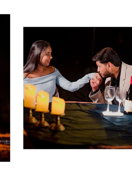 A classic romantic gesture during a candlelight dinner themed shoot. The groom kisses the bride's hand across the table, creating a chivalrous and timeless image.