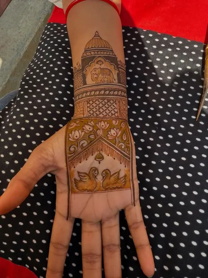 The palm design with the main figures filled in. The swans and the elephant scene on the wrist are now complete, ready for the surrounding patterns.