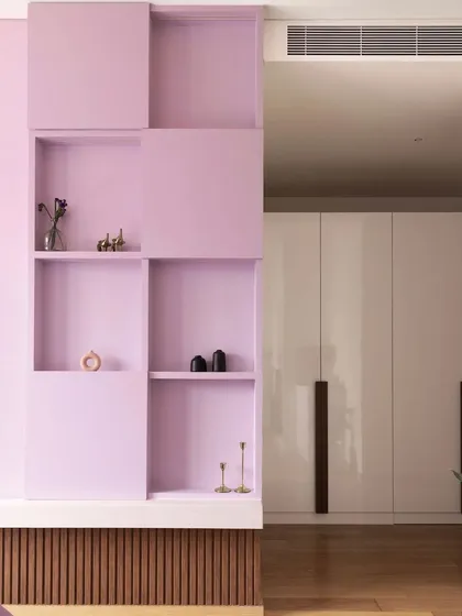 In the purple-themed bedroom, I designed this geometric open-and-closed shelving unit. It provides space for display and storage while adding a modern, sculptural element to the room.