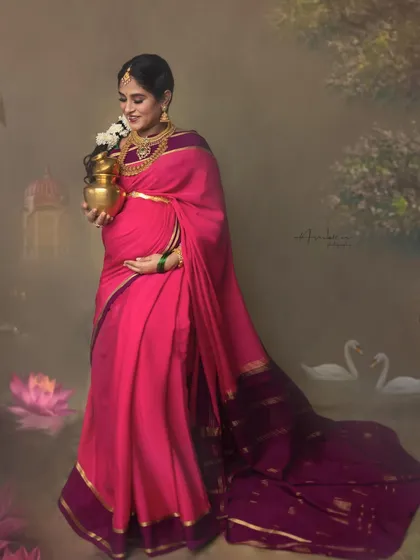 Holding a traditional brass pot, the mother-to-be is framed by swans and a dreamy landscape. This conceptual portrait is rich with symbolism and cultural storytelling.