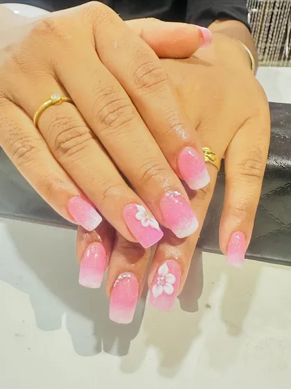 This pink and white ombre set has a beautiful shimmer. The 3D flowers on the accent nails make this a sweet and feminine choice.
