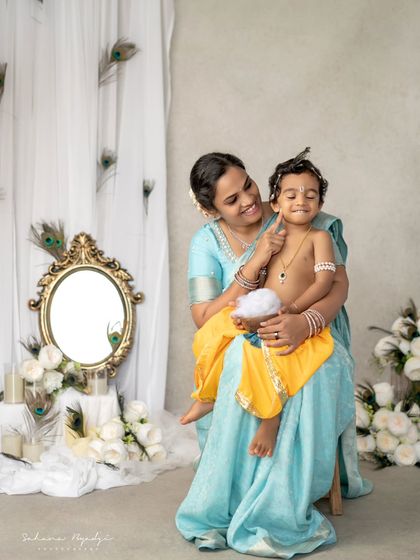 A mother and her little Krishna, sharing a playful moment. The joy in this photo is infectious.