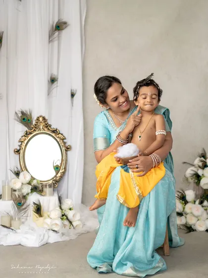 A mother and her little Krishna, sharing a playful moment. The joy in this photo is infectious.