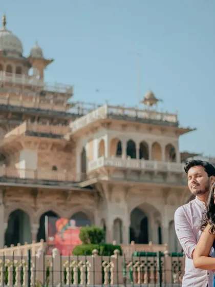 A sun-drenched, peaceful moment. This photo captures the couple enjoying the warmth and quiet, with the grand museum providing a stunning backdrop.