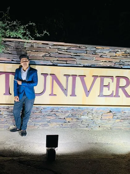 Posing by the NIIT University sign. Performing for students is a unique experience that requires a blend of entertainment and relatability. It's about showing them that the impossible is possible.