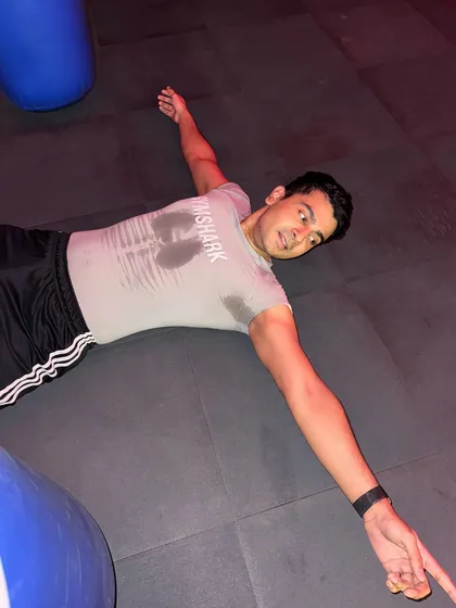 That feeling when you've given it your all. A client lies on the floor, drenched in sweat but accomplished after a tough workout.