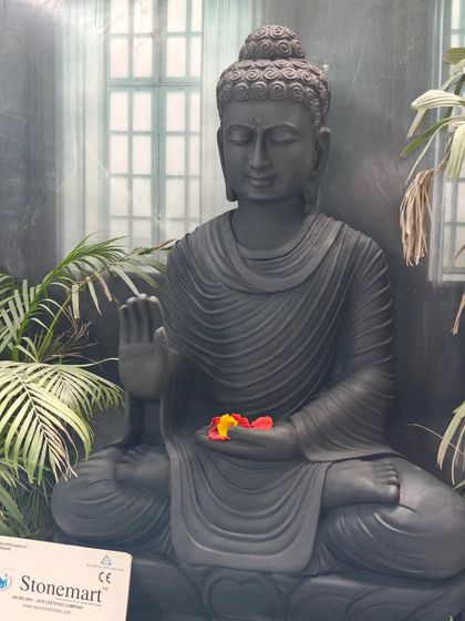 A close-up of the calm and meditative face of our 4-foot black marble Buddha. This statue is designed to be a focal point for meditation and tranquility in large spaces.