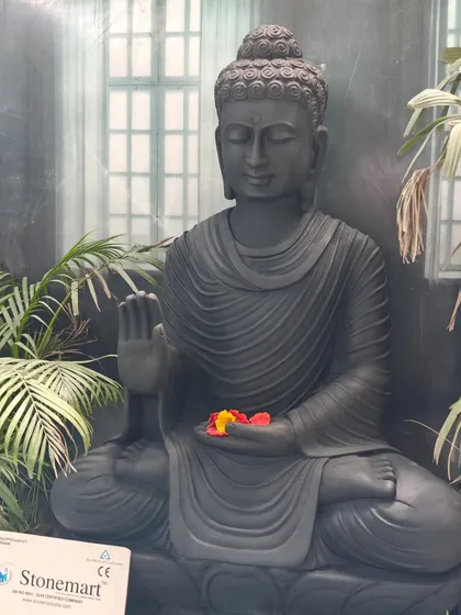 A close-up of the calm and meditative face of our 4-foot black marble Buddha. This statue is designed to be a focal point for meditation and tranquility in large spaces.
