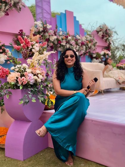 Taking a moment to sit on the colorful stage before a Mehendi event. The vibrant pastel decor with floral arrangements was the perfect setting for a fun-filled afternoon.