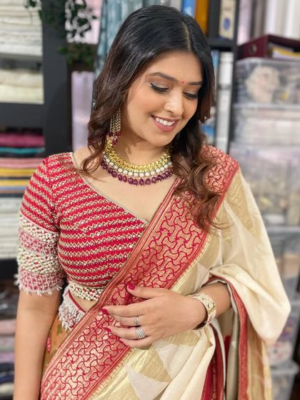 A candid moment showing the soft, romantic feel of this traditional look. The gentle waves in her hair and the radiant makeup create an aura of effortless beauty.