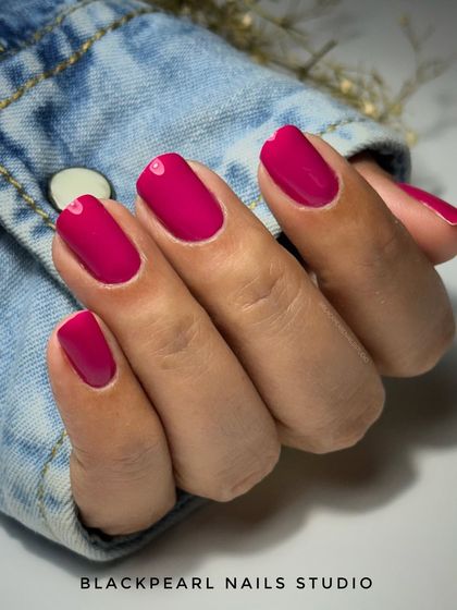 This set showcases the strength and beauty of a BIAB (Builder in a Bottle) manicure with a vibrant pink gel polish. The tiny heart detail at the cuticle adds a subtle, cute touch to the otherwise minimalist design.