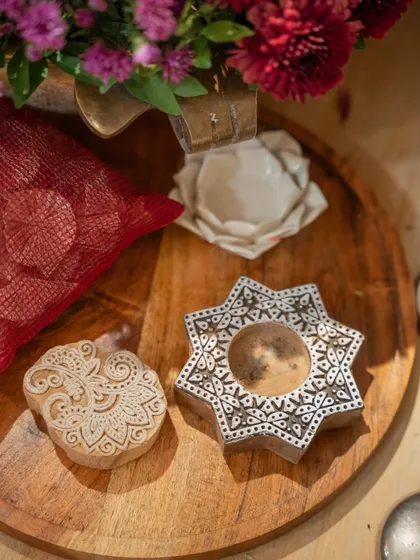 Traditional wooden block-print stamps used as decorative elements, adding an authentic, artistic touch to the table setting.