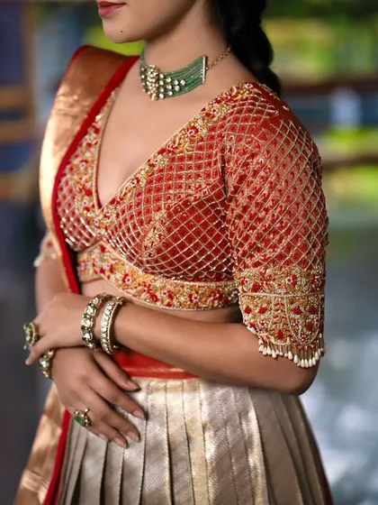 A closer look at the heart of my craft. This is a deep-V-neck bridal blouse, intricately designed with a jaal or net pattern of zardozi and threadwork. The detailed floral embroidery along the borders and sleeves makes it a versatile masterpiece that can elevate any lehenga or saree.