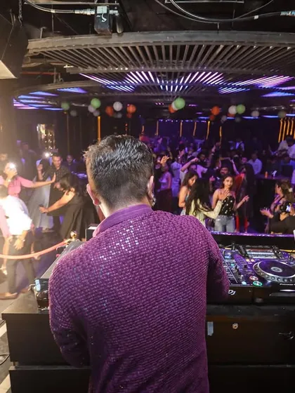 A view from behind the console, showing the packed dance floor and pyrotechnics. This is the full sensory experience I provide.