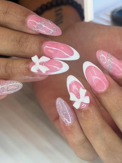 This coquette-style design is all about feminine details. It features a clean white outline on a pink base, accented with glitter and delicate 3D white bows.
