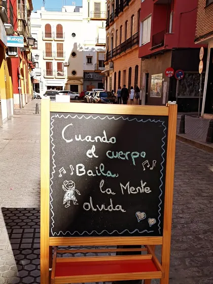 A sign I spotted on a street in Andalusia that says it all: "Cuando el cuerpo baila la mente olvida" or "When the body dances, the mind forgets." This is the soul of my teaching. Flamenco is my home, and I strive to share its profound ability to bring you into the present moment.