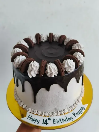 A classic Oreo drip cake, with cookies and cream frosting, a rich chocolate drip, and more Oreos on top.