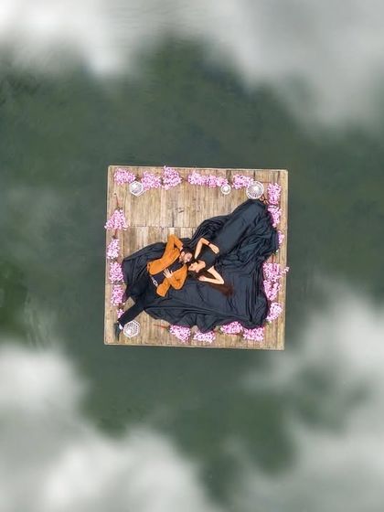 A stunning aerial drone shot of a couple on a floating raft, creating a unique and breathtaking perspective for a pre-wedding photo.