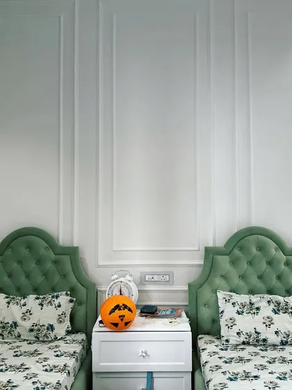 A detail shot of the neo-classical wall moulding in the twin kids' room. This simple yet effective technique adds a layer of architectural interest and sophistication to the wall, elevating the overall design of the room.