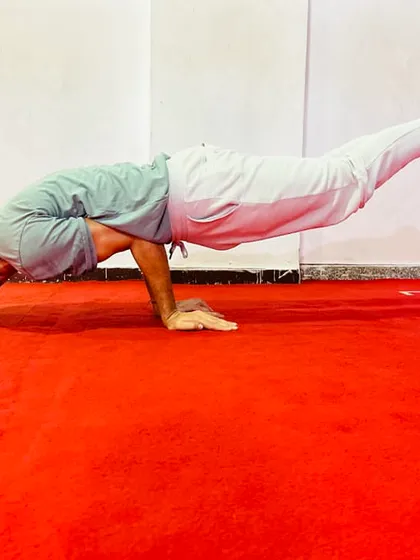 Mayurasana, or Peacock Pose, is a powerful arm balance that strengthens the entire digestive system. It requires significant wrist and core strength to hold the body parallel to the ground.