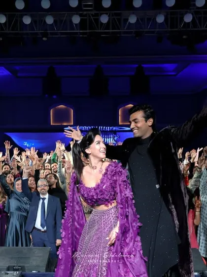 The couple on stage with the crowd fully engaged behind them. I design events that break the barrier between the stage and the audience, creating a unified, electrifying party.