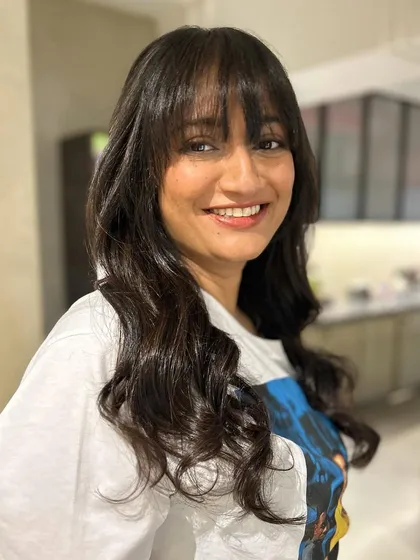 Soft textured bangs paired with long layers and subtle peek-a-boo highlights. This is a great way to update your look without a drastic change.