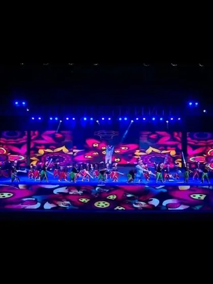 I coordinate vibrant entertainment for corporate events, like this large-scale dance performance. The stage is brought to life with dynamic LED backdrops and professional stage lighting, creating a memorable experience for all attendees.