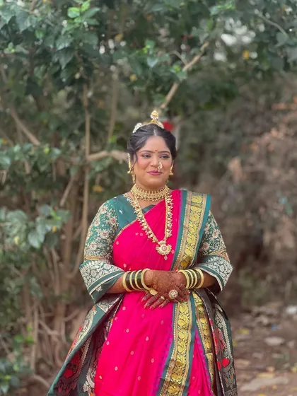 A full-length view of the bride's traditional look. The makeup is designed to complement the entire ensemble, making her look perfect from head to toe.