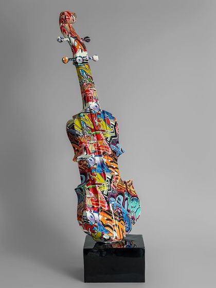 This graffiti-style violin sculpture blends classical form with street art flair. Covered in an explosion of colors and patterns, it rests on a sleek black base, making it a unique showpiece for a music or art enthusiast's room.
