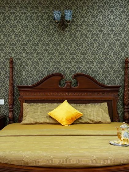 A detailed shot of the four-poster bed, showcasing the fine woodwork and the luxurious feel of the space.