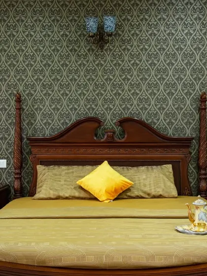 A detailed shot of the four-poster bed, showcasing the fine woodwork and the luxurious feel of the space.