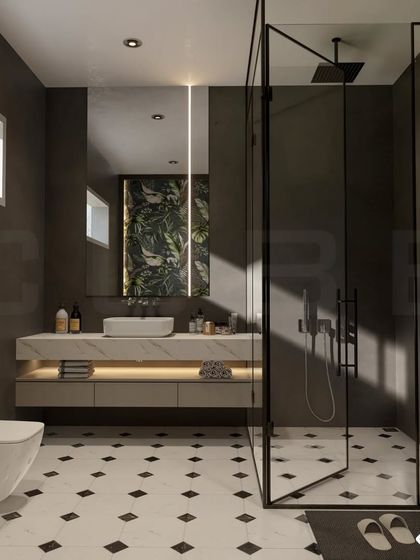 A bold, contemporary bathroom with dark grey walls and striking black-and-white geometric floor tiles. The floating vanity with under-cabinet lighting and a tropical-print accent panel behind the mirror add layers of visual interest.