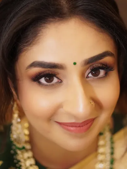 A close-up of Aditi's stunning reception makeup. The glittery eyes and soft smile are a perfect combination for a glamorous evening look that complements her traditional attire.