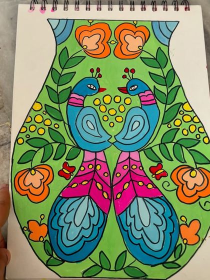 A close-up of the peacock-themed vase design, showcasing the intricate details and vibrant colour choices.