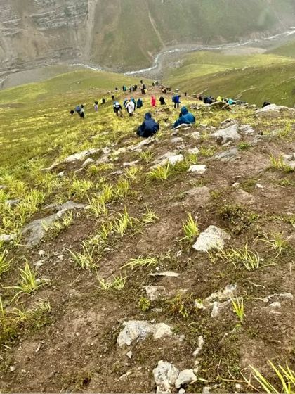 Looking down from the trail as our group makes its way up the green mountain slopes. The sense of journey and progress is a powerful feeling.