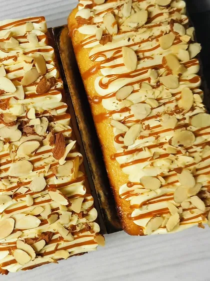 A truly decadent option, my Butterscotch, Caramel, and Almond Tea Cakes are infused with crunchy butterscotch nuts and roasted almonds, then topped with buttercream and a caramel drizzle.