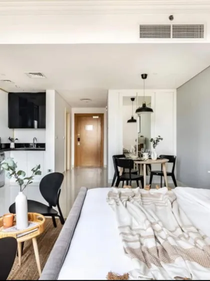 A 3D visualization of a compact studio apartment layout. This helps clients understand how to maximize functionality and style in a smaller footprint.