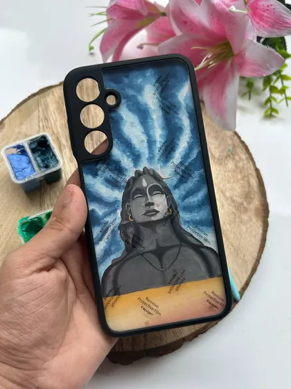 This Adiyogi Shiva design is a very powerful and popular request. I painted this piece using gouache on high-quality paper, focusing on the serene expression and the vibrant energy of the background. It is then fitted into a protective phone case.