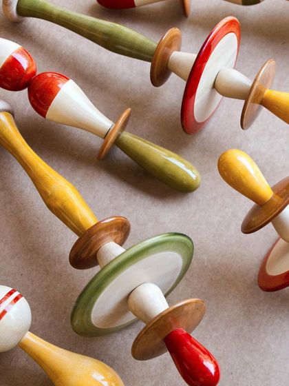 A collection of finished Channapatna modules, showcasing the playful forms and rich, natural colors. Each component was designed to come together as part of a larger, dynamic installation.