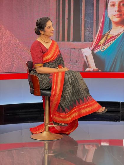 A side profile on the studio set, highlighting the simple, elegant hairstyle.