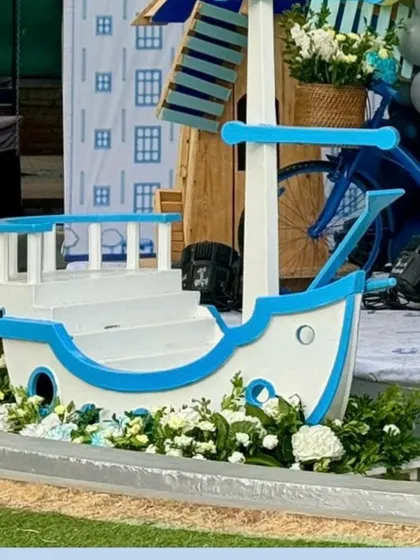 A detailed shot of the charming boat prop, surrounded by fresh white flowers.