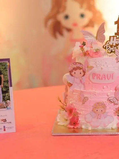 A close-up of the angel-themed first birthday cake, showing the delicate details.