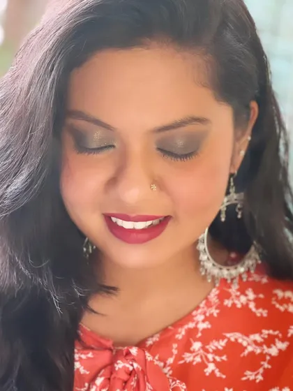 For a different event, we switched to a sultry smokey eye. This look is perfect for an evening function, with earthy tones on the eyes and a deep red lip, paired with statement silver earrings.
