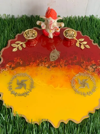 The festive red and yellow pooja platter, complete with a small Ganesha idol. It's ready for your Rakhi or Diwali celebrations.