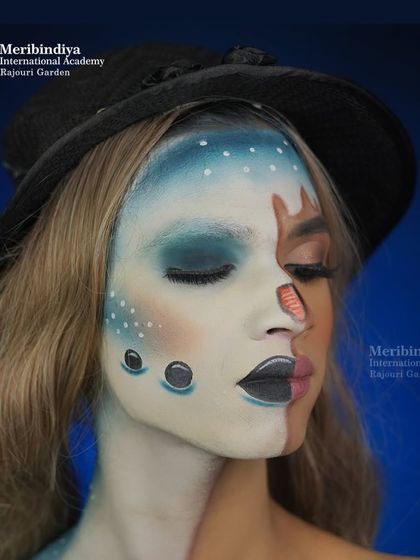A creative half-face look inspired by winter. This showcases skills in blending fantasy elements with natural makeup.