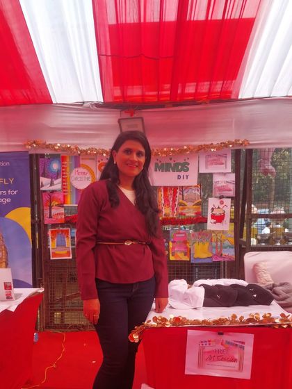 Standing proudly at my stall, surrounded by the beautiful artwork created in my classes. These events are a great way to showcase the kids' talent.