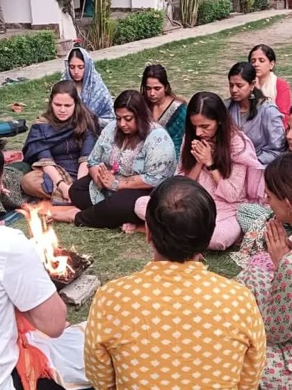 Students participate in an outdoor Havan, connecting with the element of fire and the purifying power of ancient mantras.