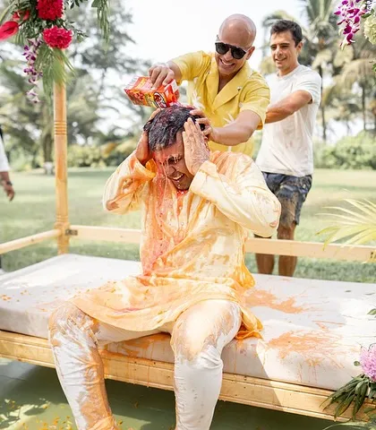 The groom's Haldi gets wild! Friends and family shower him with everything from turmeric and curd to ketchup and beer, making for hilarious and unforgettable photos.