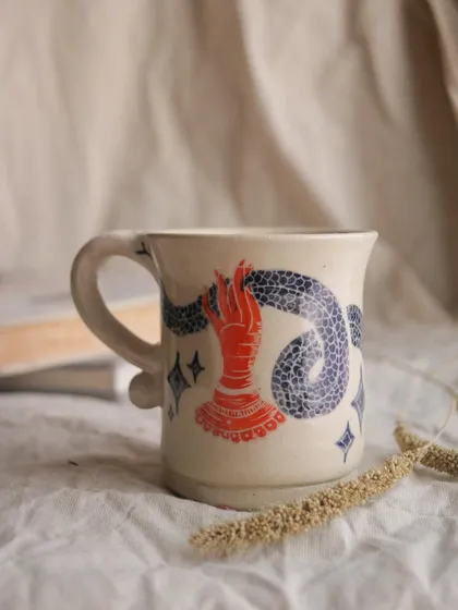 The 'Slithering Time' mug. I used the sgraffito technique on this piece, carving through a layer of color to reveal the clay body underneath. It creates such a beautiful, illustrative effect.